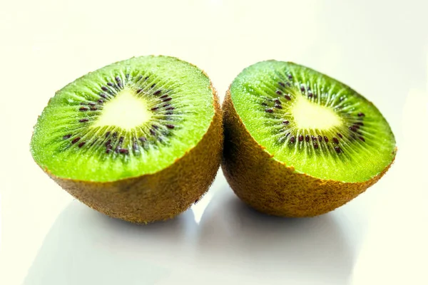 Kiwi Fruit Gesneden Twee Stukken Tegen Een Lichte Achtergrond Close — Stockfoto