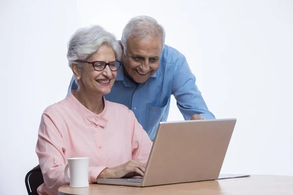 Senior couple looking at laptop together