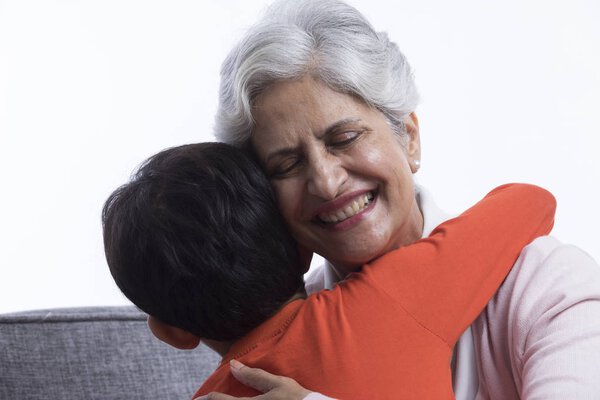 Boy hugging his grandmother
