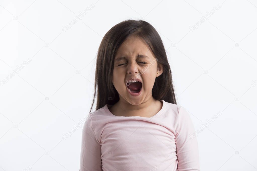Portrait of little girl yawning 