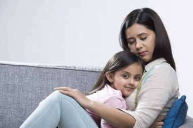 Anne ve kızı kanepede rahatlatıcı