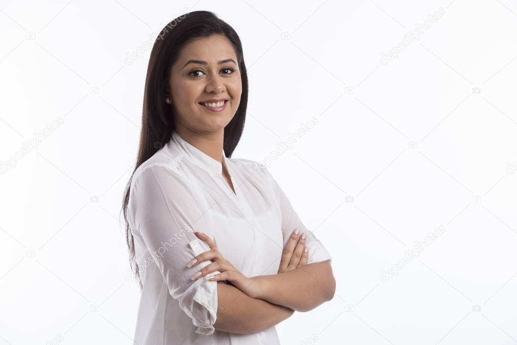 Portrait of smiling woman standing arms crossed