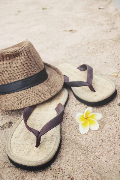 Chinelos com chapéu na praia — Fotografia de Stock