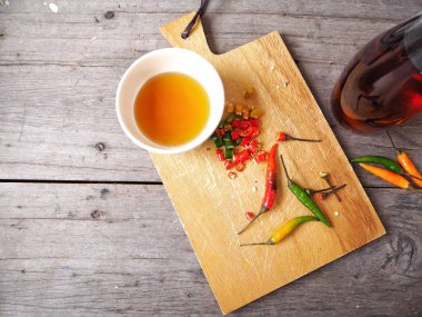 Ahşap arka plan üzerinde kırmızı biber soslu taze balık