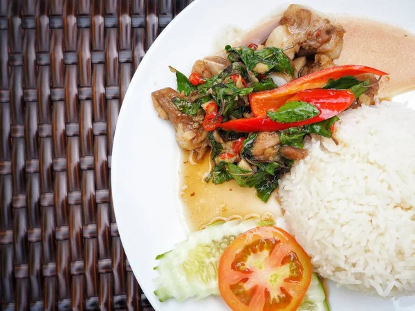 Tay fesleğen domuz eti pilav ve beyaz tabakta sebze ile servis