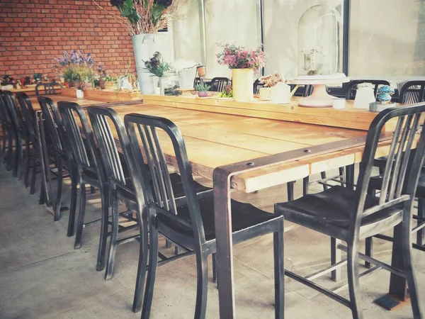 Table with chairs at restaurant on background,close up