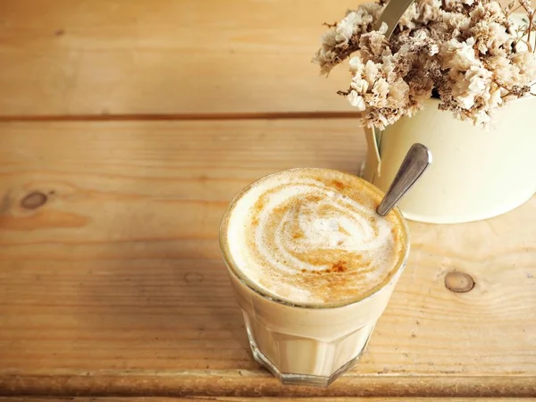 Coffee with milk and dried flowers