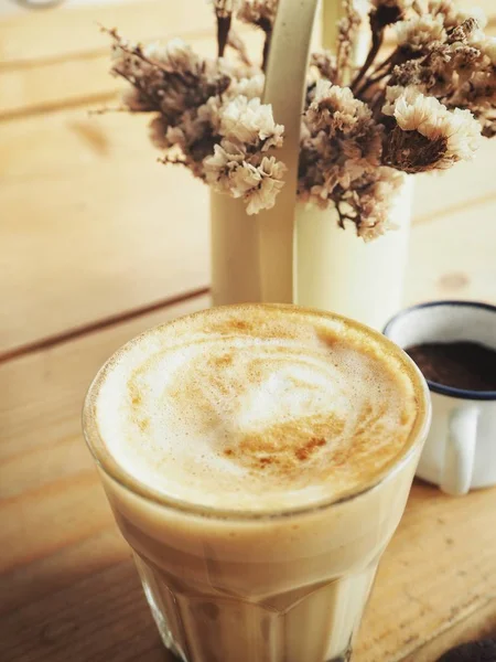 Coffee with milk and dried flowers — Stock Photo, Image