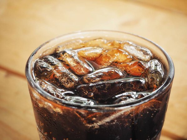 close-up view of soda drink with ice cubes in glass