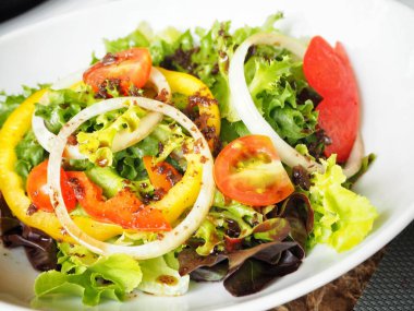 Beyaz tabakta taze sebze salatası görünümü Kapat