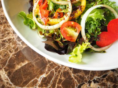 Beyaz tabakta taze sebze salatası görünümü Kapat