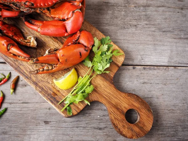 Kireç veya limon ahşap arka plan üzerinde ile servis haşlanmış yengeç pençeleri