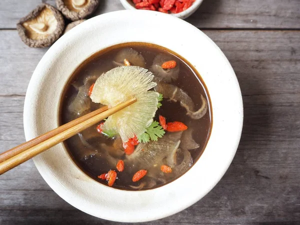 Köpekbalığı yüzgeci ahşap arka plan üzerinde ile geleneksel Çince çorba 