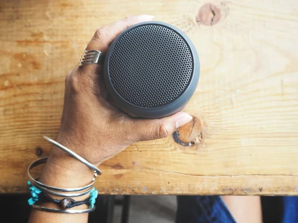 bluetooth hoparlör tutan kadın görüntüsünü kırpılmış