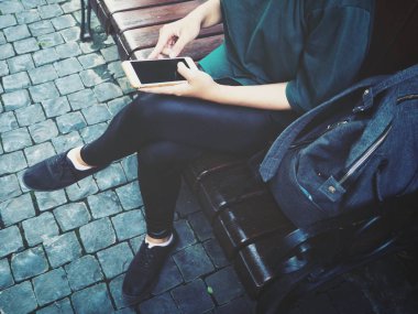 Çanta ile akıllı telefon kullanan kadın