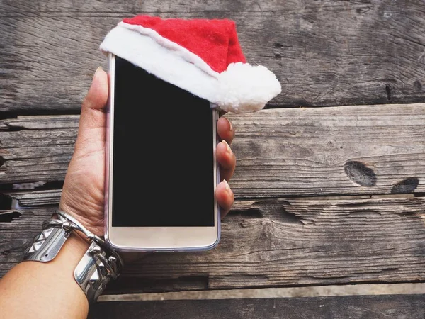 Telefon yandan Noel şapka ile akıllı