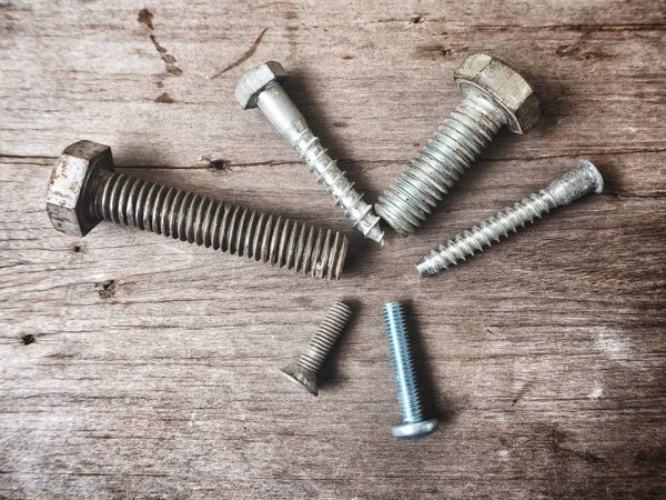 Top View Metal Construction Screws Wooden Table — Stock Photo, Image