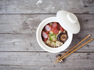 Geleneksel Çin yemeği kızarmış pilav sosis ve mantar ahşap arka plan üzerinde