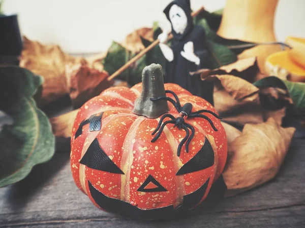 Halloween pumpkin with scary face on wooden background