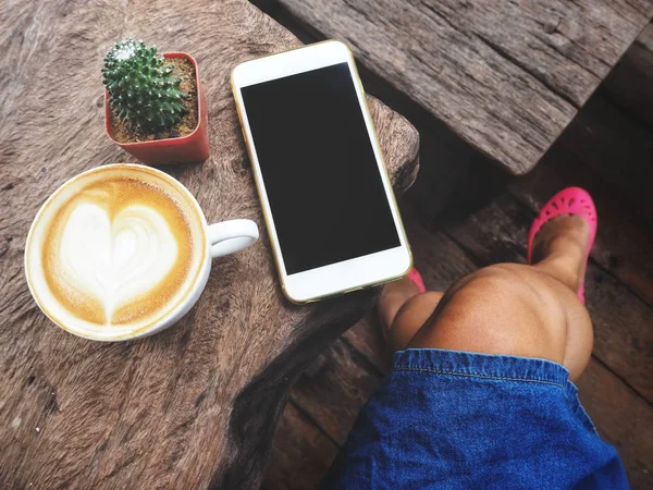 Cropped Shot Female Legs Smartphone Blank Screen Cup Cappuccino — Stock Photo, Image