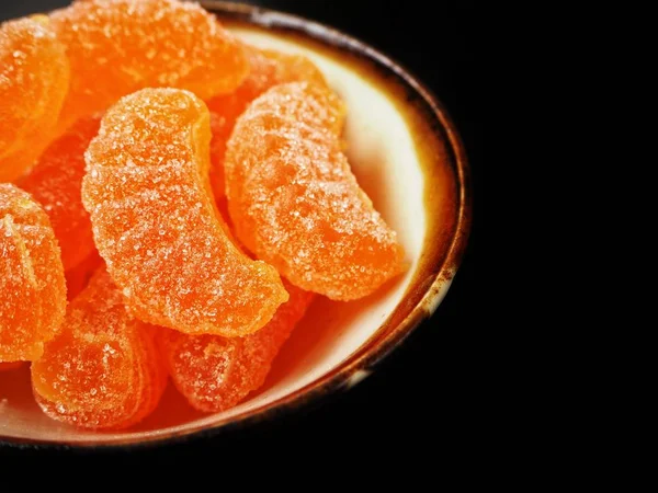 Orange candy on black background — Stock Photo, Image