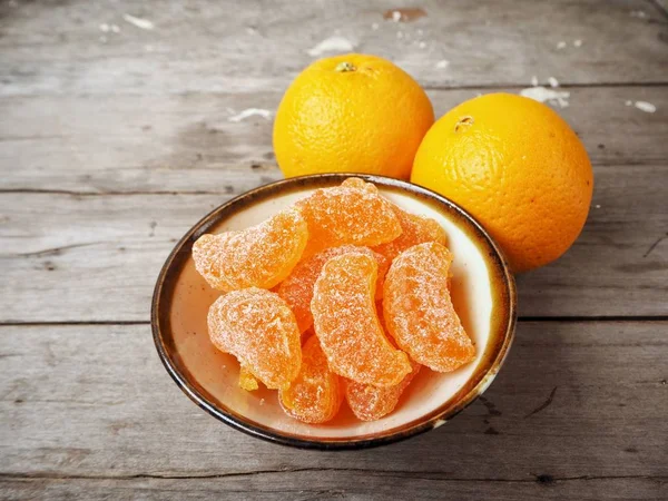 Orange candy on wood background — Stock Photo, Image