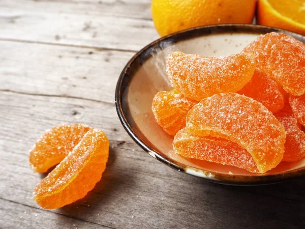 Orange candy on wood background — Stock Photo, Image
