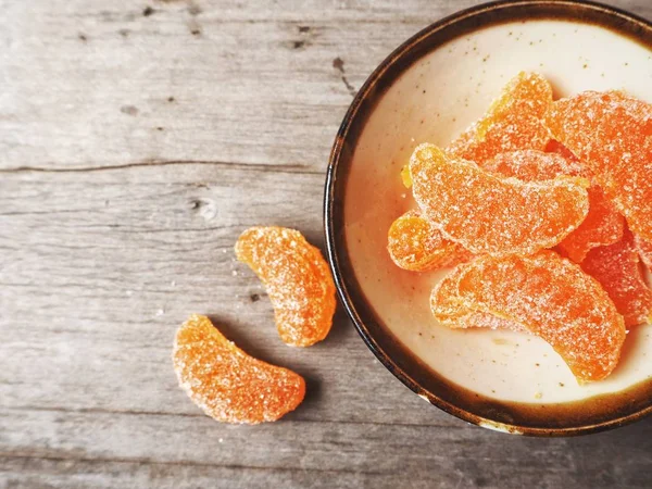 Orange candy on wood background — Stock Photo, Image