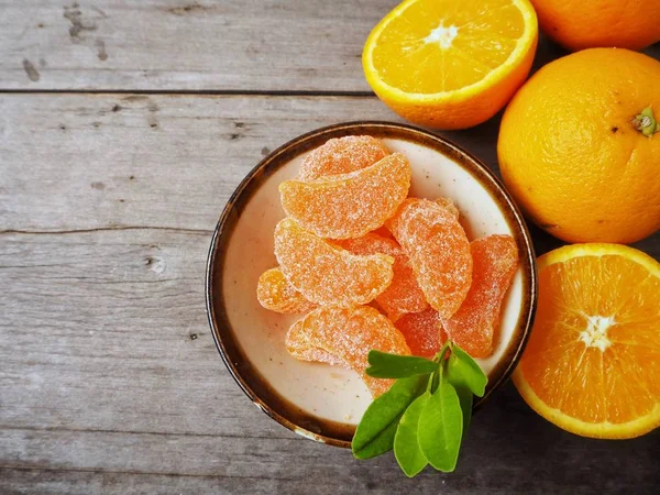 Orange candy on wood background