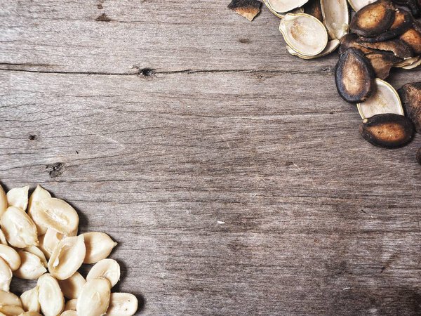 Pile of watermelon seeds on wooden background