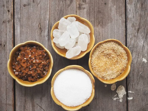 Bambu kase eski ahşap arka plan üzerinde beyaz ve kahverengi şeker