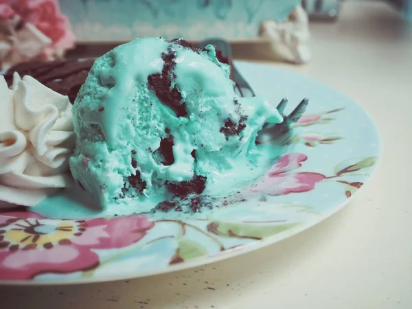 Mint Ice cream served with chocolate cake on vintage plate