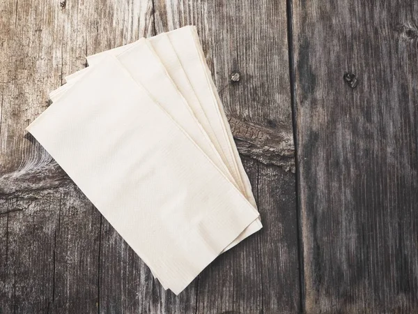 Pile of paper napkins on wooden background