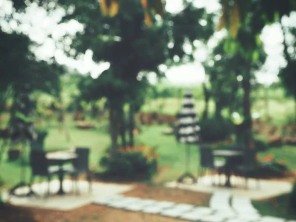 Blurred tables with chairs at outside restaurant