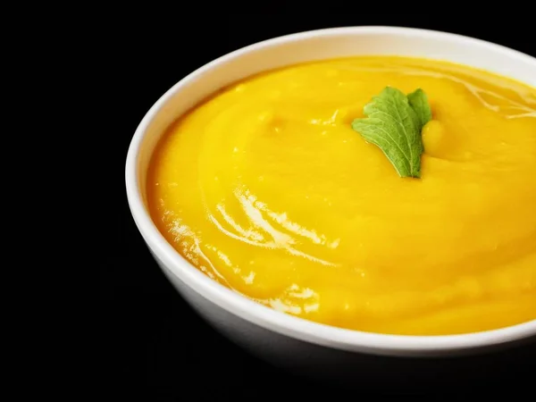 Pumpkin soup on black background — Stock Photo, Image