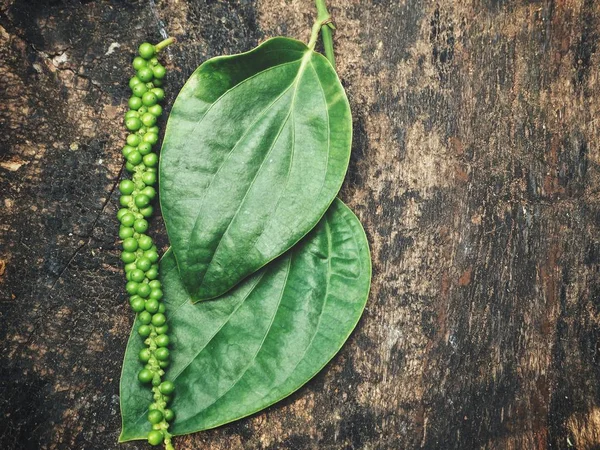 Peppercorns sobre fondo de madera —  Fotos de Stock