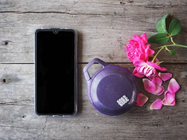 Smart phone and bluetooth speaker with rose flower