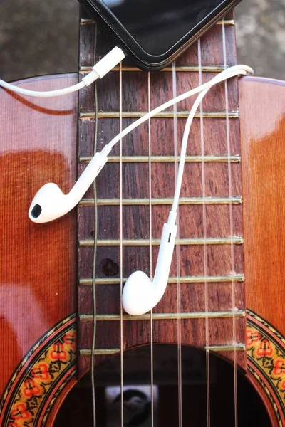 Guitar and smartphone with earphone