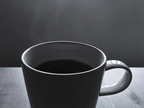 Café negro en taza de cerámica blanca con humo caliente flotando — Foto de Stock