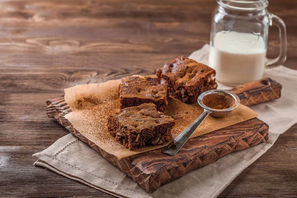 Brownie con leche sobre un fondo de madera oscura —  Fotos de Stock