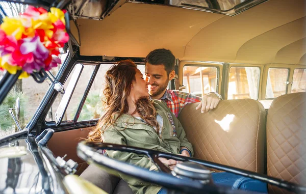 Woman and man enjoy in classic van.