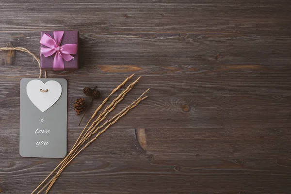 Box with a gift on a wooden dark background, with an inscription, space for text, top view — Stock Photo, Image