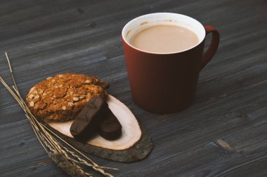 kupa kahve ve bisküvi koyu ahşap bir masa üzerinde