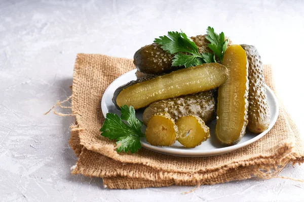 pickled cucumbers with herbs and onions in a plate on the table Probiotics food Copy space