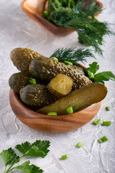 pickled cucumbers with herbs and onions in a plate on the table Probiotics food Copy space Vertical