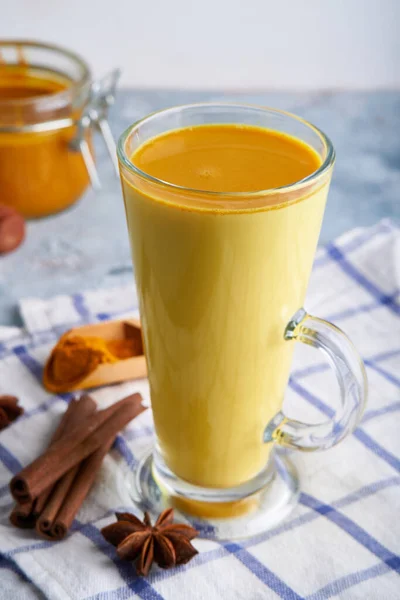 Turmeric milk. Cooked golden milk in a glass