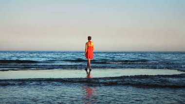 Genç kadın okyanus kıyılarında Tavira, Portekiz izlerken