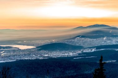 Sunset on top of the double-Headed hills of the national Park Taganay. The view of the city of Zlatoust and the most ancient of the South Ural mountains. clipart