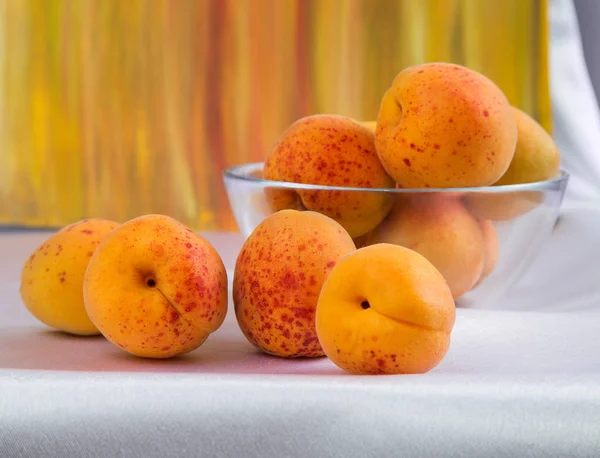 Bright yellow and orange auricos on a white tablecloth — Stock Photo, Image