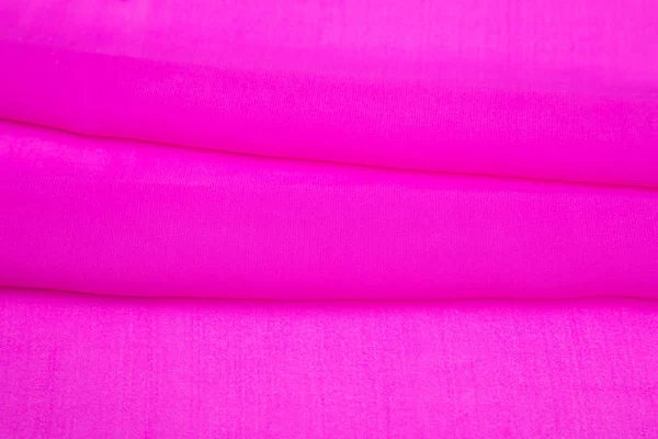 Tecido de luz rosa dobrado — Fotografia de Stock